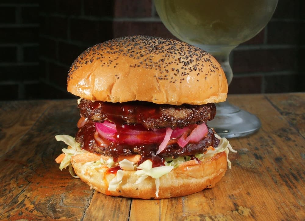 The Gangnam Burger ($9.99) is a Korean-style burger with gochujang sauce and pickled onions. (Courtesy Jakes Burgers and Beer)