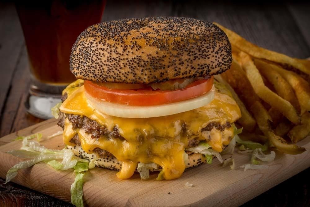 The Double Cheeseburger ($9.79) comes with two fresh beef patties, two slices of cheese, onions, lettuce, tomato, pickles and mustard on a poppy seed bun. (Courtesy Jakes Burgers and Beer)