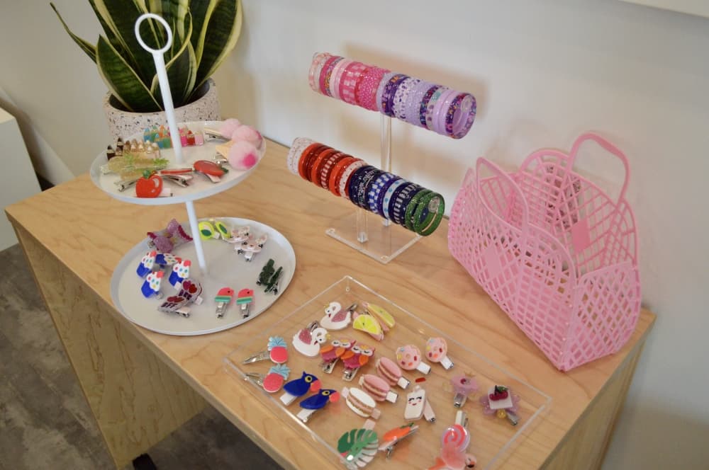 The salon has a retail section with local authors' books, hair accessories, clothing and kid-friendly spa products like bath bombs. (Taylor Girtman/Community Impact Newspaper)