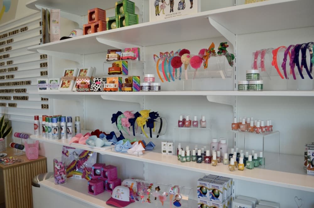The salon has a retail section with local authors' books, hair accessories, clothing and kid-friendly spa products like bath bombs. (Taylor Girtman/Community Impact Newspaper)