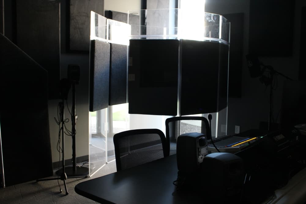 Collin College's video production students have access to a soundproof booth and control panels that connect to a green screen room. (Brooklynn Cooper/Community Impact Newspaper)