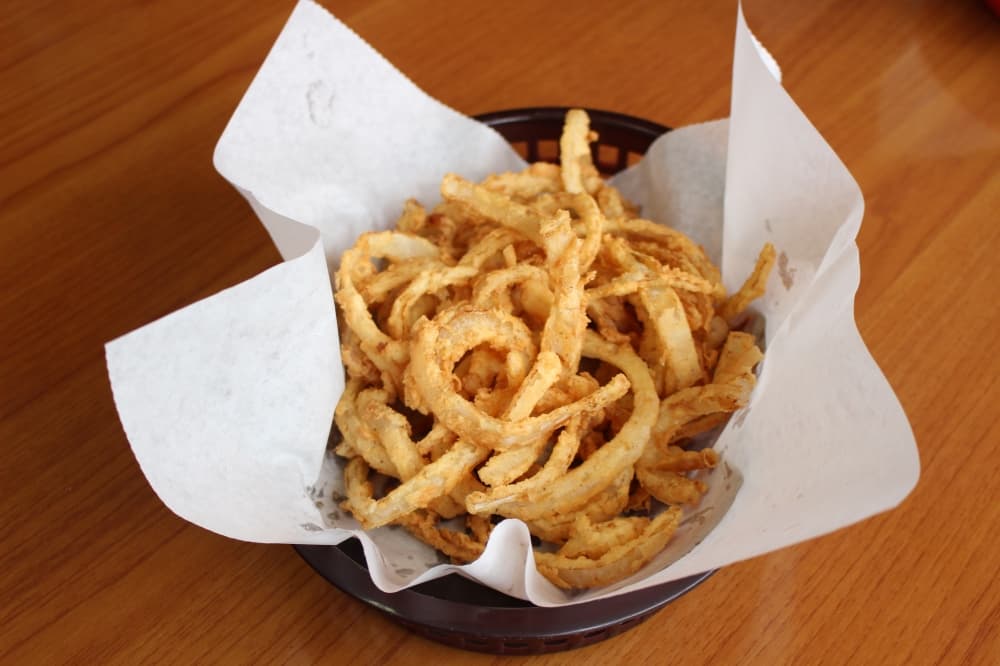 Onion rings ($5.99) are coated with seasoned batter before they are fried. (Andrew Christman/Community Impact Newspaper)