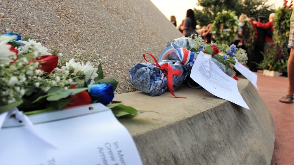 Attendees placed flowers at the 9/11 Flight Crew Memorial to honor the victims. (Sandra Sadek/Community Impact Newspaper)