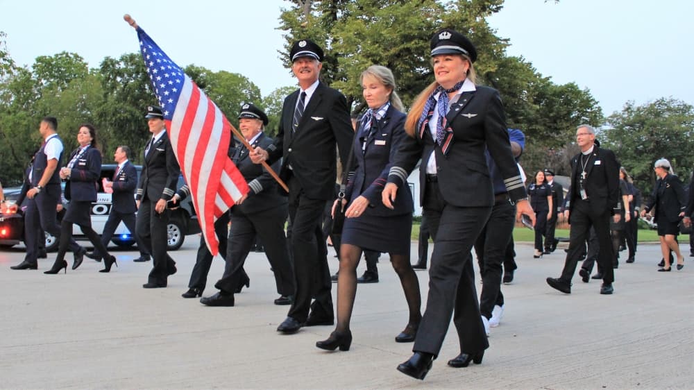 American Airlines flight personnel, led by flag-bearer Ret. Capt. Greg Heckrodt marched together to the Grapevine 9/11 Flight Crew Memorial. (Sandra Sadek/Community Impact Newspaper)