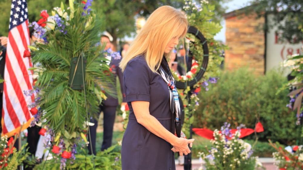An American Airlines flight personnel pays her respects at the memorial. (Sandra Sadek/Community Impact Newspaper)