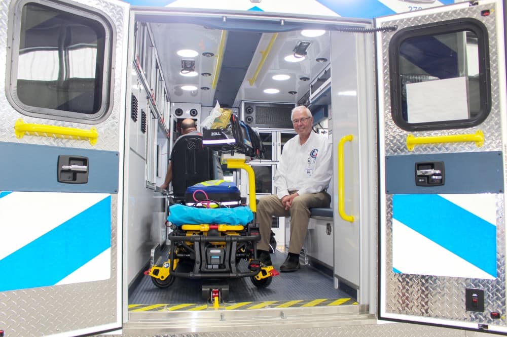 ESD 11 Mobile Healthcare CEO Doug Hooten smiles from within one of the district’s new ambulances. (Wesley Gardner/Community Impact Newspaper) 