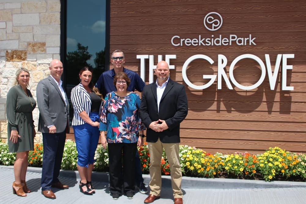 The Howard Hughes Corp. executive team celebrated the grand opening of Creekside Park The Grove on Aug. 20. (Andrew Christman/Community Impact Newspaper)