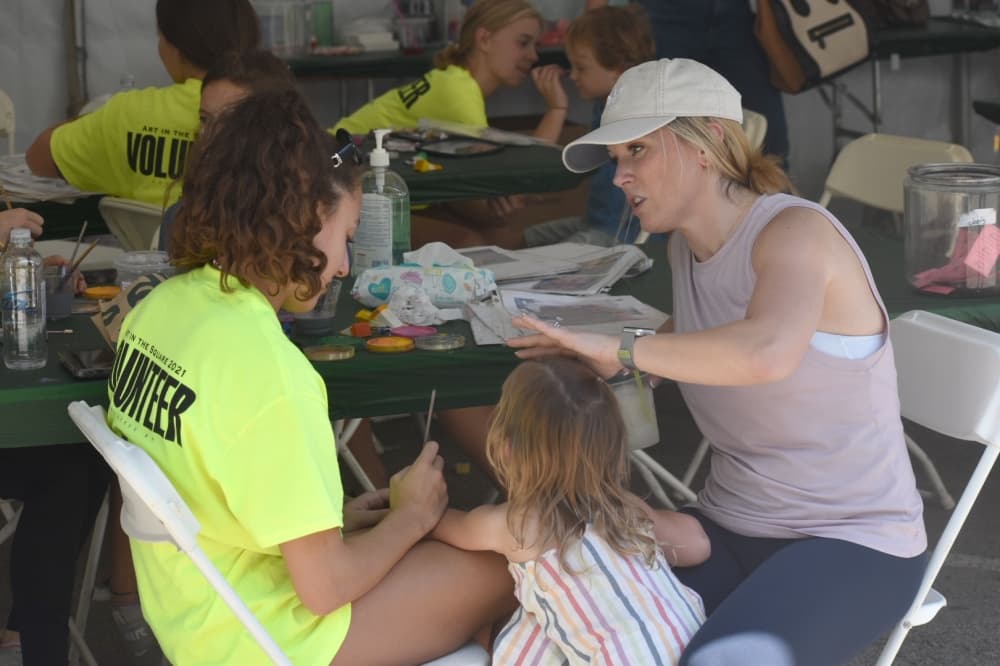 Adley Taylor gets her face painted with her mother, Jessica, in "Kid Korner" at Art in the Square on Sept. 26 in Southlake Town Square. (Anjali Krishna/Community Impact Newspaper)