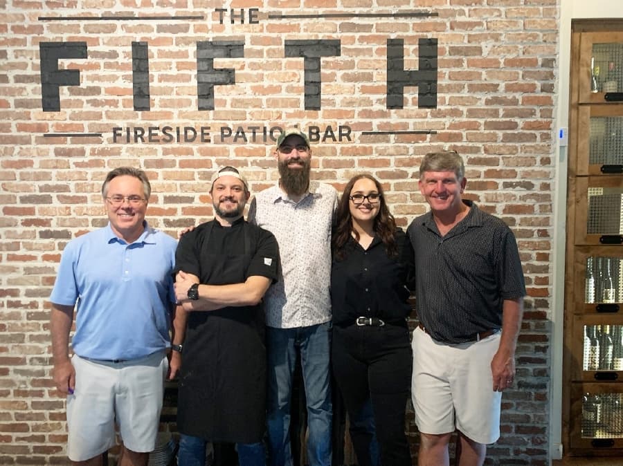 Owners Don Bouvier (left) and Greg Cooney (right) run the bar with chef Brian Parker (second from left), bartender Jared Short (center) and general manager Trystan Watson (second from right). (Erick Pirayesh/Community Impact Newspaper)
