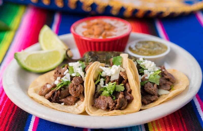 The plate comes with grilled steak, onions, cilantro and queso on corn tortillas ($9.99). (Courtesy Herbert's)