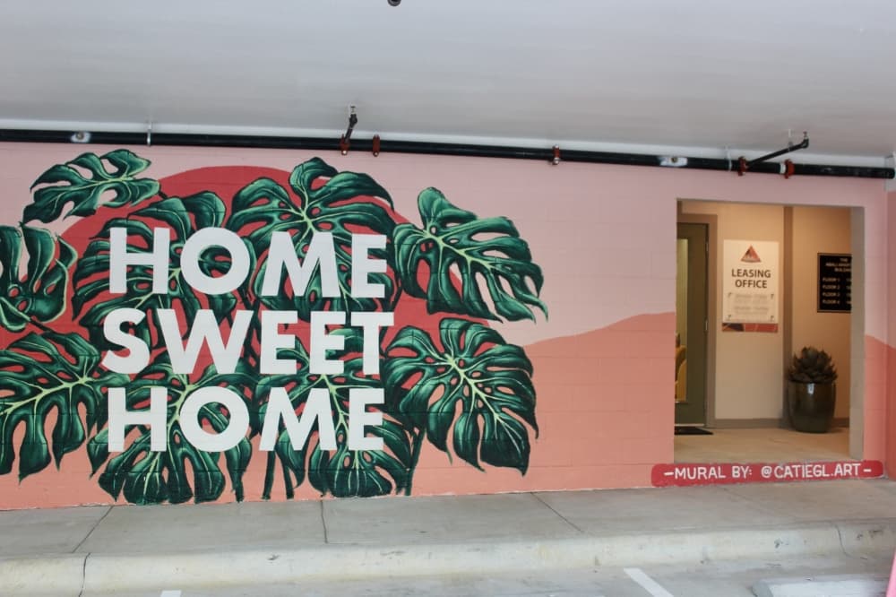 Catie Lewis is one of several Texas artists to paint a mural at the complex. (Ben Thompson/Community Impact Newspaper)