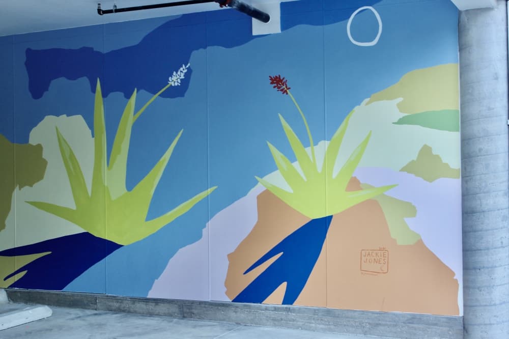 Jackie Jones is one of several Texas artists to paint a mural at the complex. (Ben Thompson/Community Impact Newspaper)