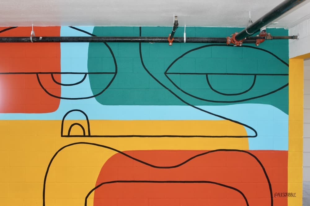 Alannah Tiller is one of several Texas artists to paint a mural at the complex. (Ben Thompson/Community Impact Newspaper)