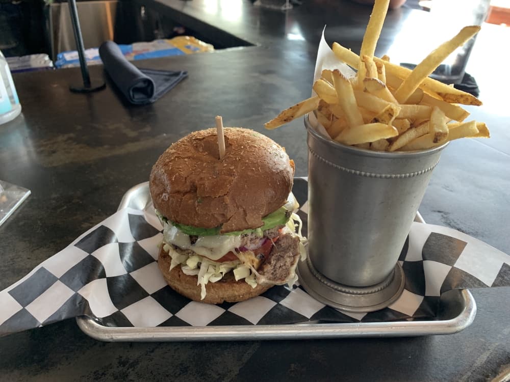 The Gobbler ($9) is a turkey patty that comes with sliced tomato, red onion, swiss cheese, sliced avocado and basil aioli served on a wheat bun. A side of fries can be added for $3. (Nicole Barron/Community Impact Newspaper)