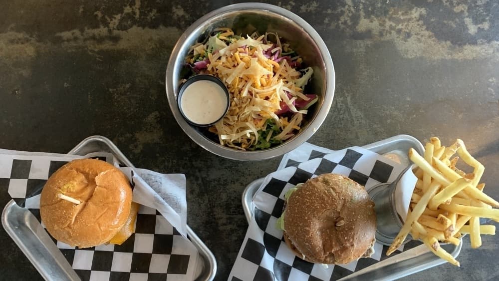 In addition to burgers, salads are also available at Grind Burger Bar. (Nicole Barron/Community Impact Newspaper)