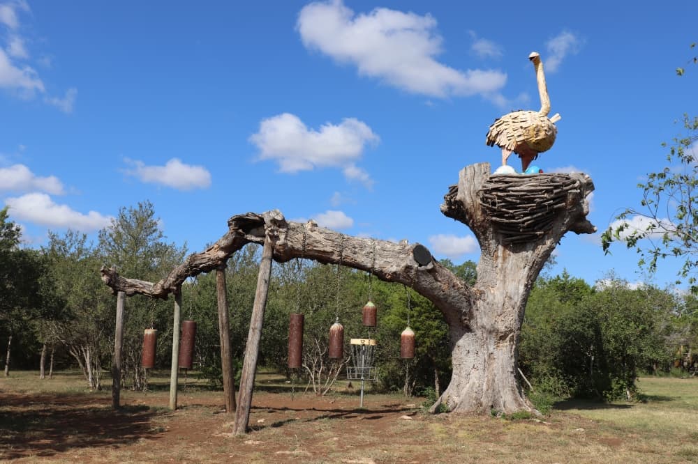 The Big Bird Bell Hole features an ostrich with a nest of eggs and bells obstructing the basket.
