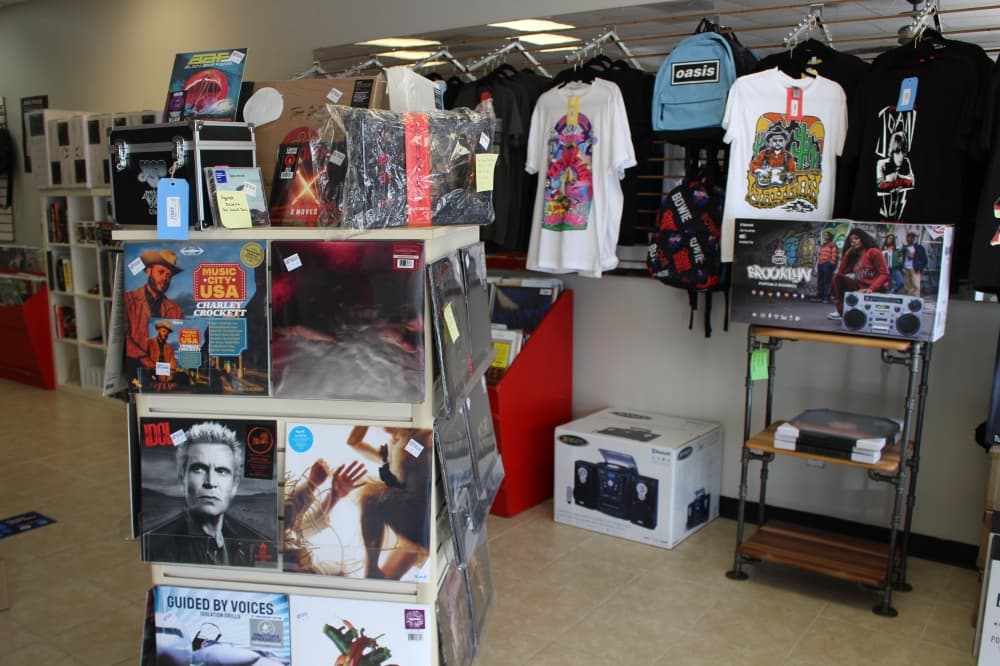 
The entrance of Volume Music has new releases of clothing and records on display.