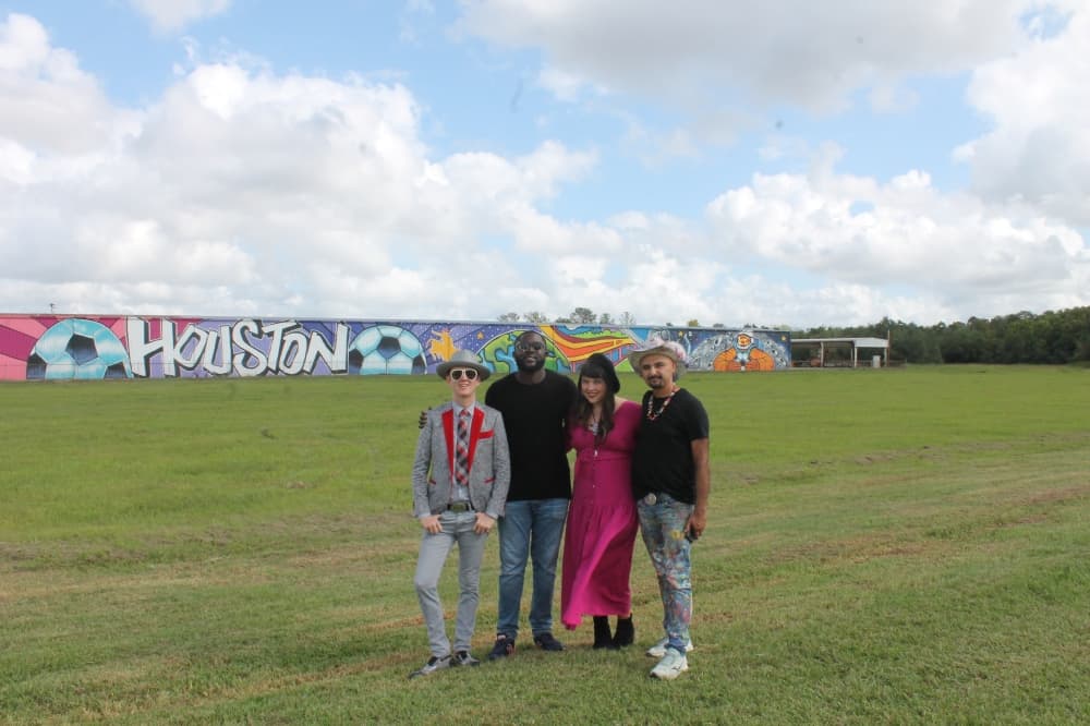 From left, Alton DuLaney, Mathieu Jean Baptiste, Hannah Bull and Mario Figueroa Jr. stand in front of the mural at its unveiling Oct. 12. DuLaney serves as curator of public art at the Houston Airport System, while Jean Baptiste, Bull and Figueroa Jr. all assisted in creating the mural. (Sierra Rozen/Community Impact Newspaper)