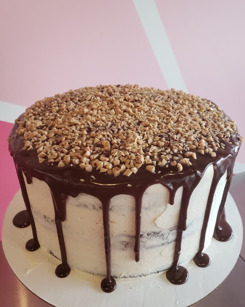 This chocolate toffee cake has a chocolate cake base with toffee buttercream, chocolate ganache drip and toffee bits. (Courtesy Scrumptious Houston)