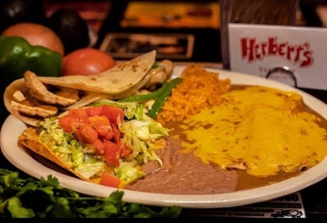 
The plate comes with two enchiladas, a fajita, a chalupa, grilled bell peppers, onions, and rice and beans. ($10.99)