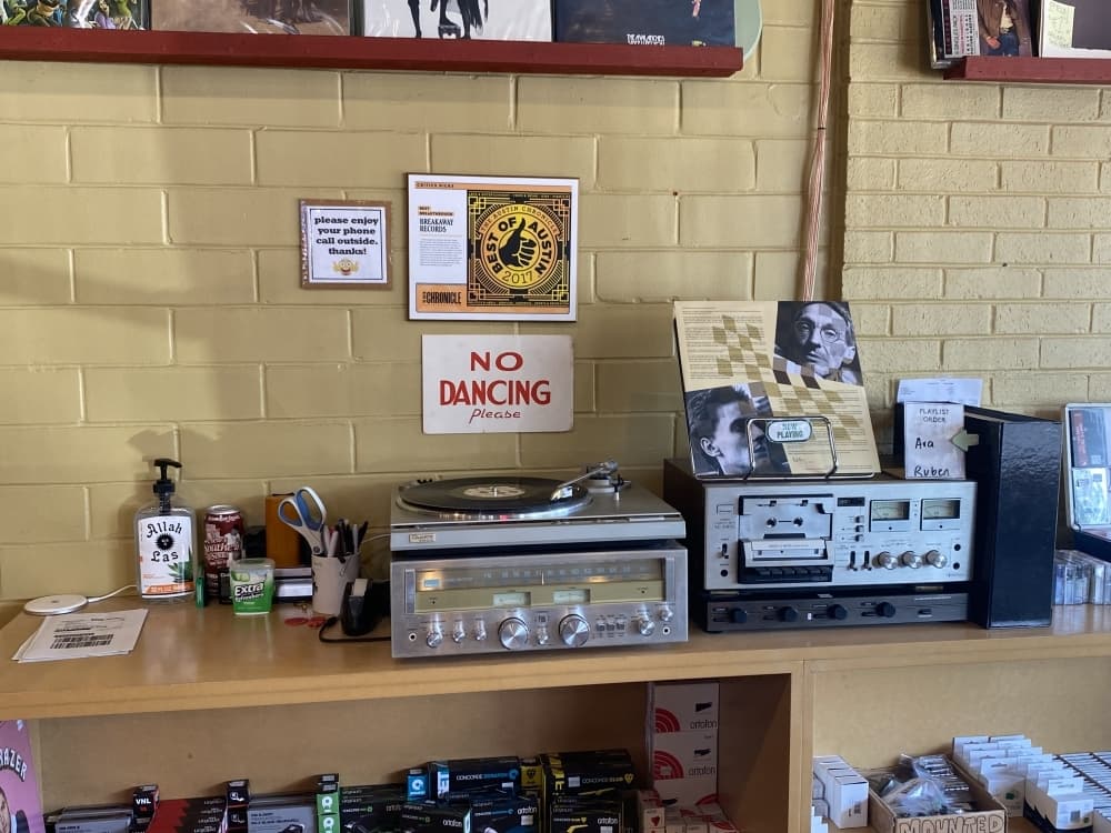 The Breakthrough Records team plays vinyls while guests shop.