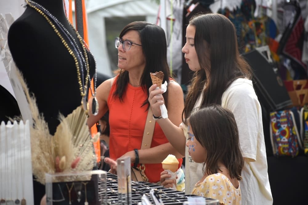 Belen Vezga purchases jewelry with her daughters, Vanessa and Mariana, at Oktoberfest. (Anjali Krishna/Community Impact Newspaper)