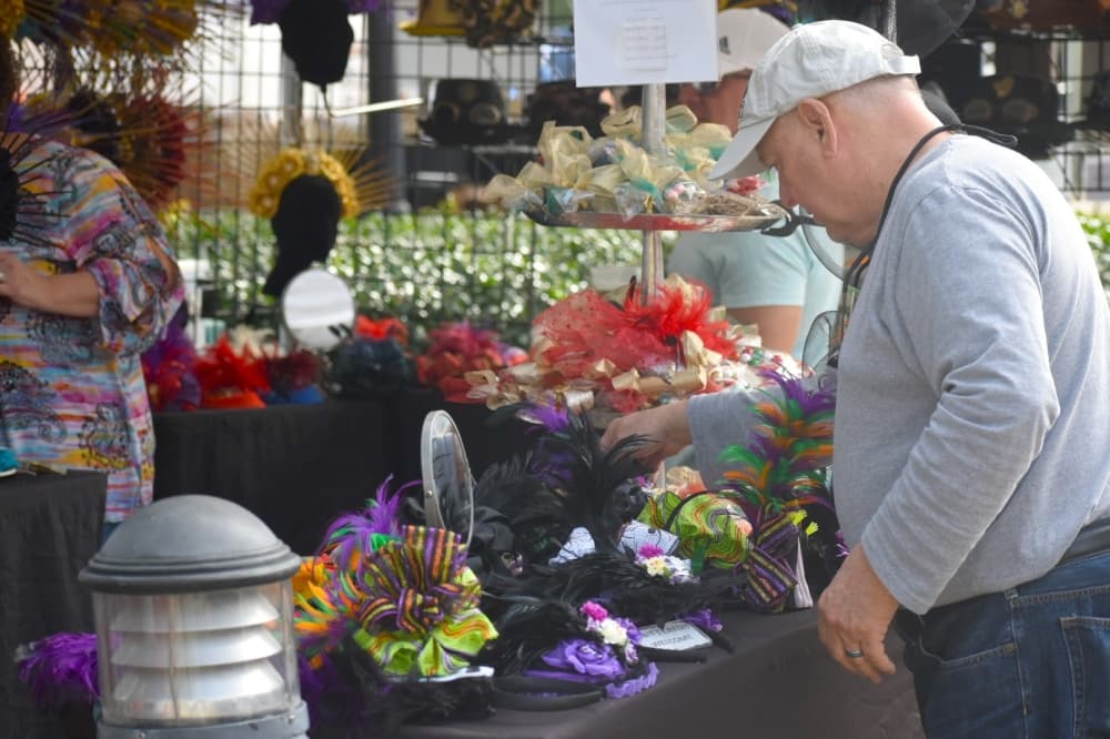 Trapper Bowman organizes the booth for his wife, Gloria, at Oktoberfest. (Anjali Krishna/Community Impact Newspaper)