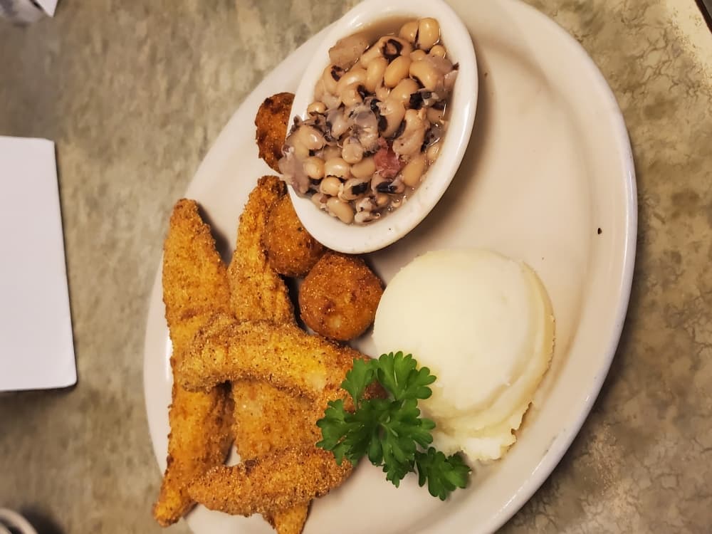 The Farm Fed Catfish ($13.50) is lightly breaded with cornmeal and served with mashed potatoes, black-eyed peas and hushpuppies. 