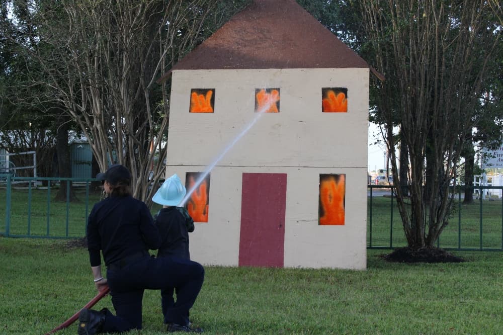 Children had the opportunity to "put out a fire" using the station's fire hose. (Chandler France/Community Impact Newspaper)