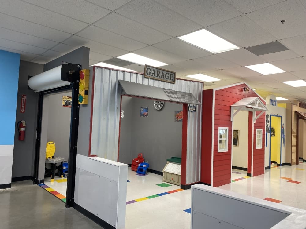 Sylliaa used her background in theater to create a street for families to play. The setup includes a garage, vet clinic, schoolhouse, diner and grocery store. (Darcy Sprague/ Community Impact Newspaper)