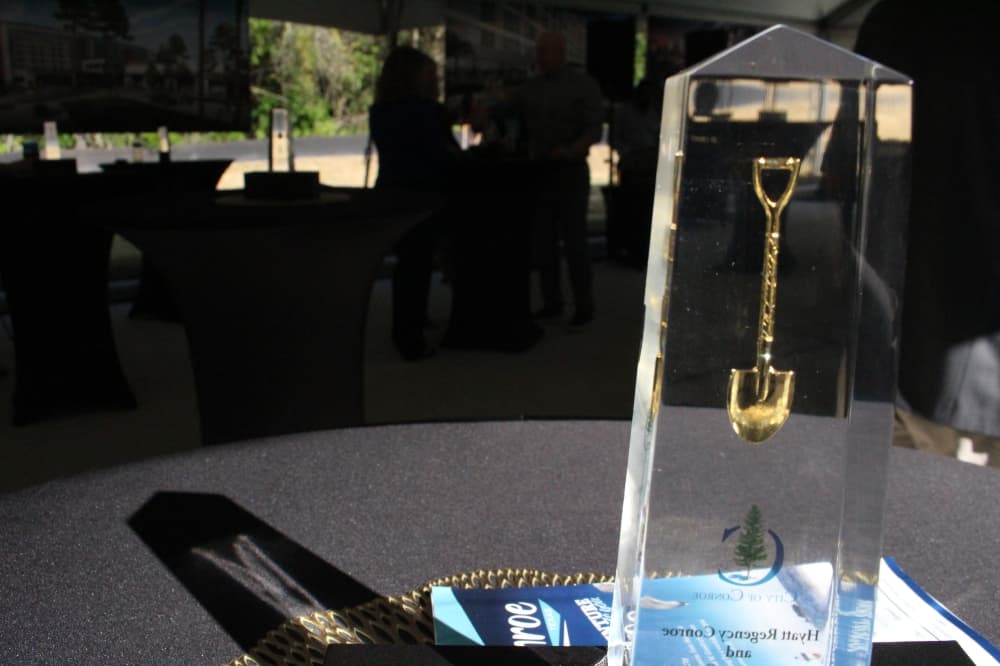 A figurine provided by Hyatt Regency, showing a glass prism with a gold shovel