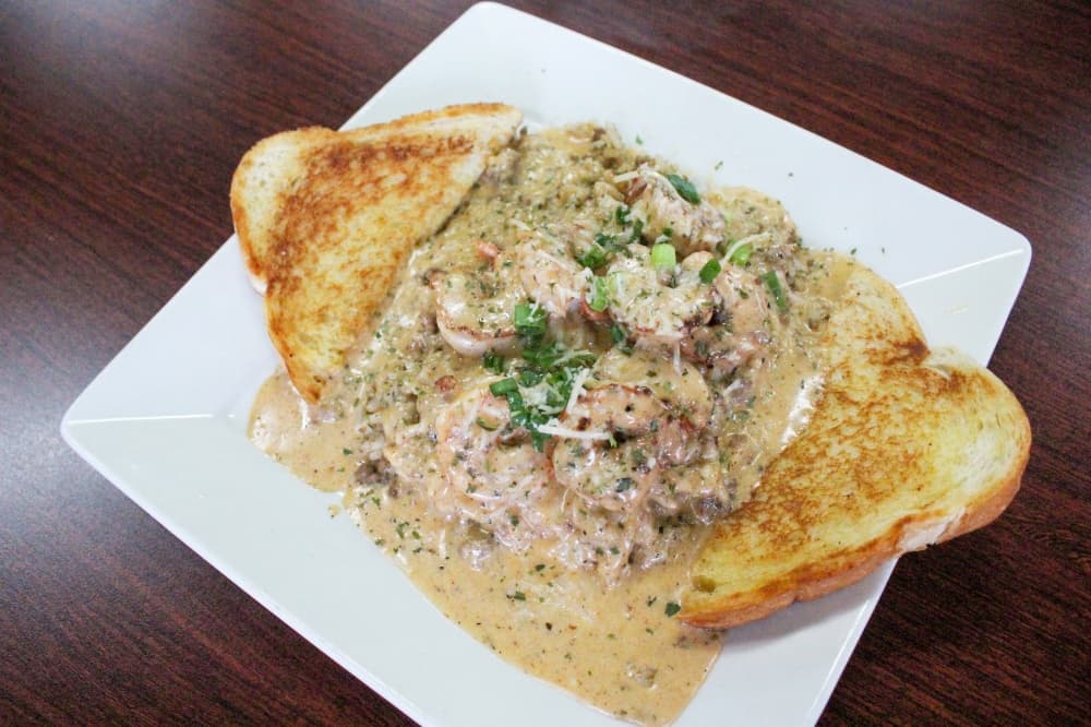 The Cajun Shrimp Plate ($13.99) features sauteed shrimp covered in a creamy Cajun sauce and served with dirty rice. (Hannah Zedaker/Community Impact Newspaper) 