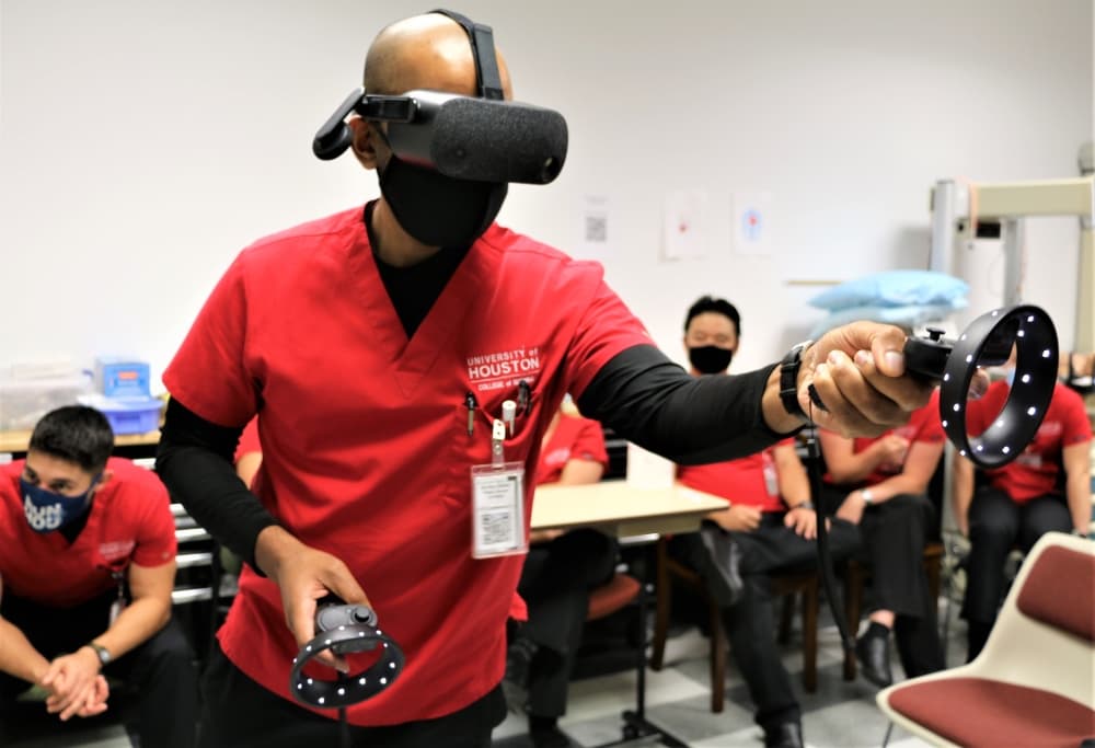 A nursing student uses virtual reality equipment to learn about operating room nursing. 