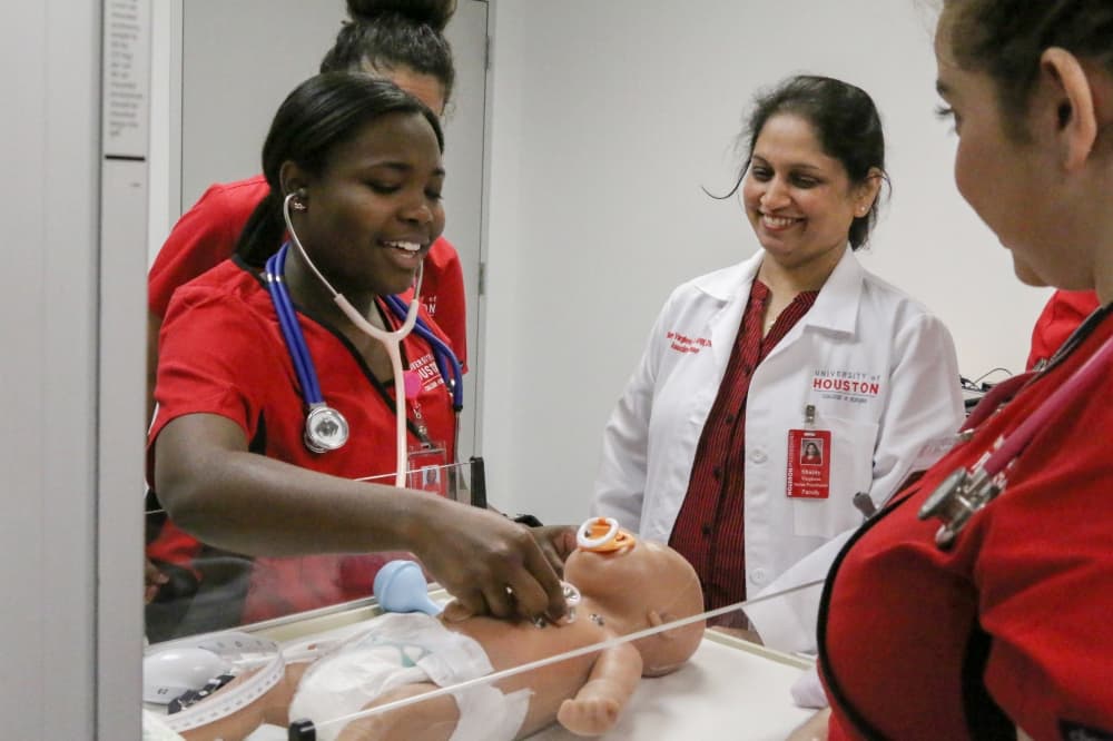 Dr. Shainy Varghese oversees students working with mannequins. The "dolls" are able to perform life-like functions for a more real student experience. 