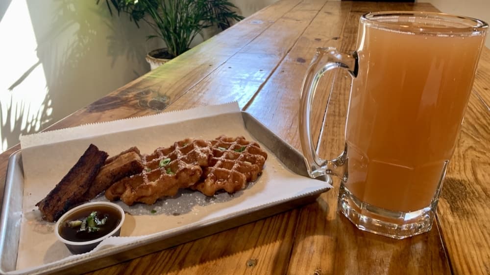 A weekend brunch menu includes Waffles N Bellies ($14.50) paired with a Guava Mimosa.