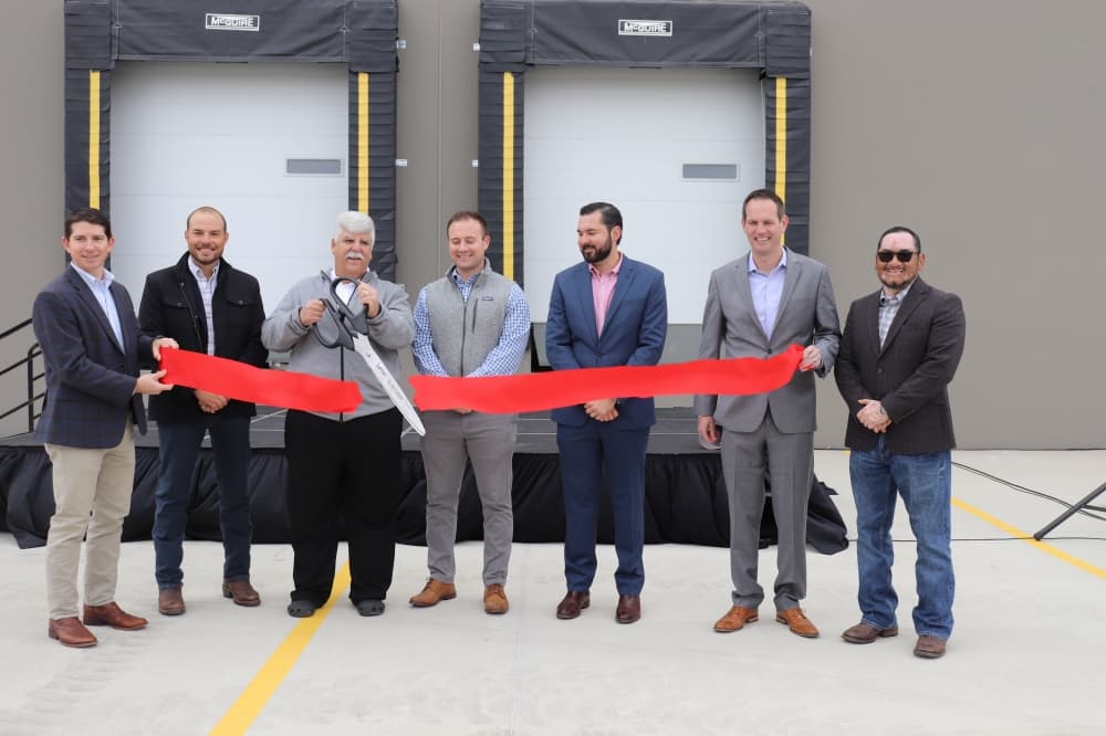 Lanter Delivery Systems officials commemorate coming to Kyle with a ribbon cutting. (Zara Flores/Community Impact Newspaper)
