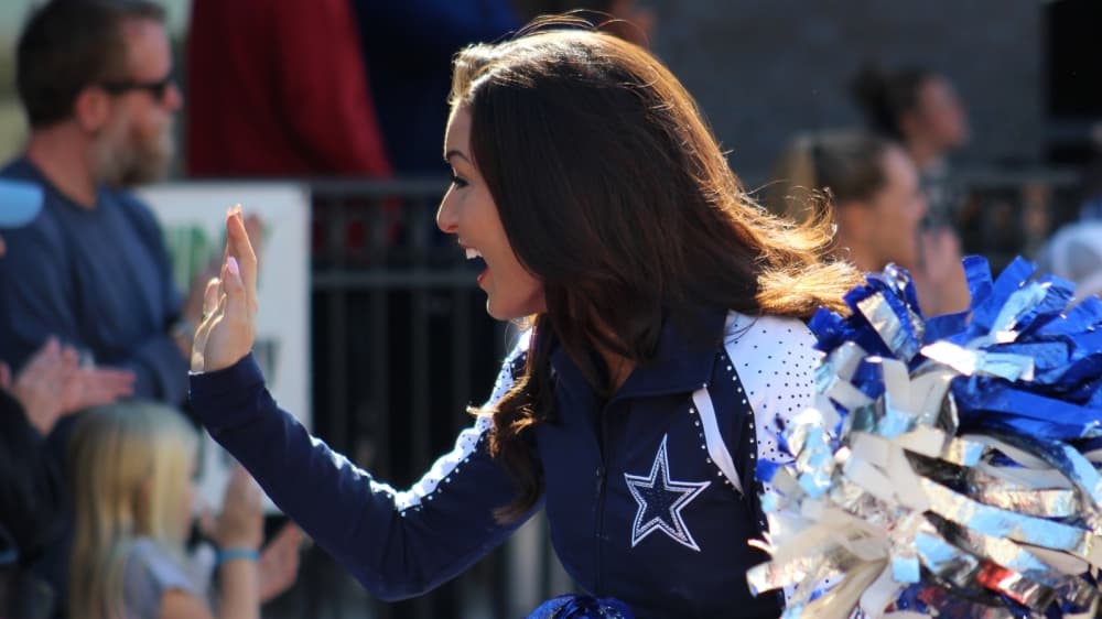 Two Dallas Cowboys cheerleaders were in attendance and waved at attendees during the parade. (Sandra Sadek/Community Impact Newspaper)