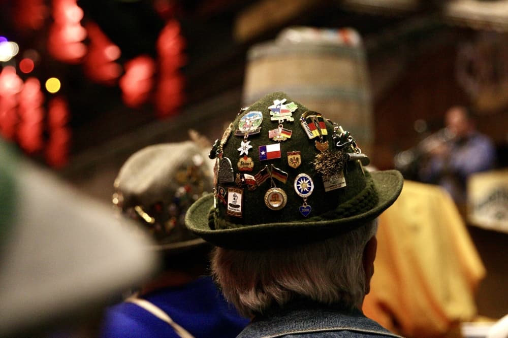 Many longtime visitors to Wurstfest don hats with commemorative pins. (Lauren Canterberry/Community Impact Newspaper)