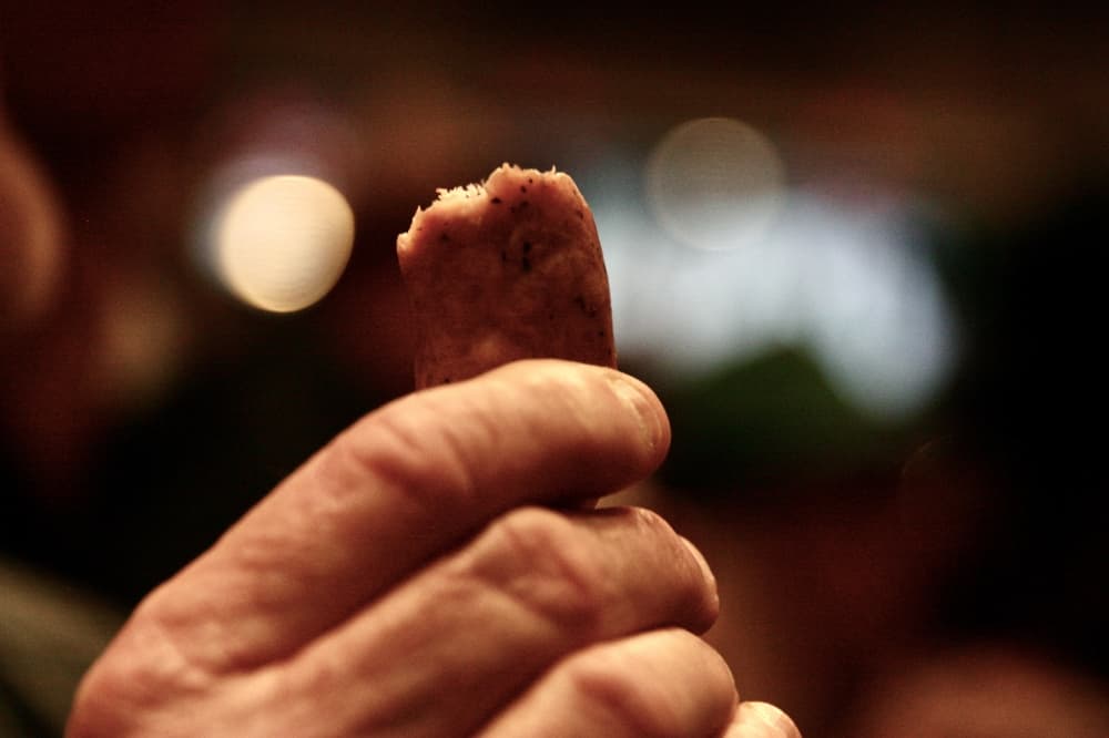 The "biting of the sausage" traditionally kicks off the festival. (Lauren Canterberry/Community Impact Newspaper) 