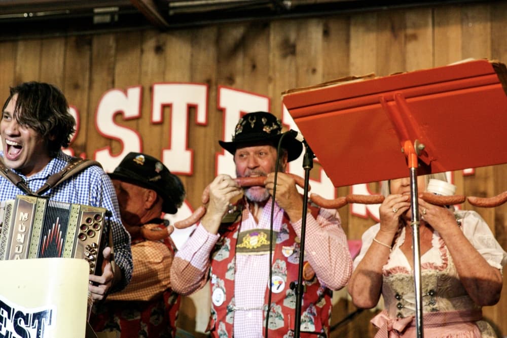 Miles Granzin takes a bite of sausage to kickstart the 2021 Wurstfest celebration. (Lauren Canterberry/Community Impact Newspaper) 