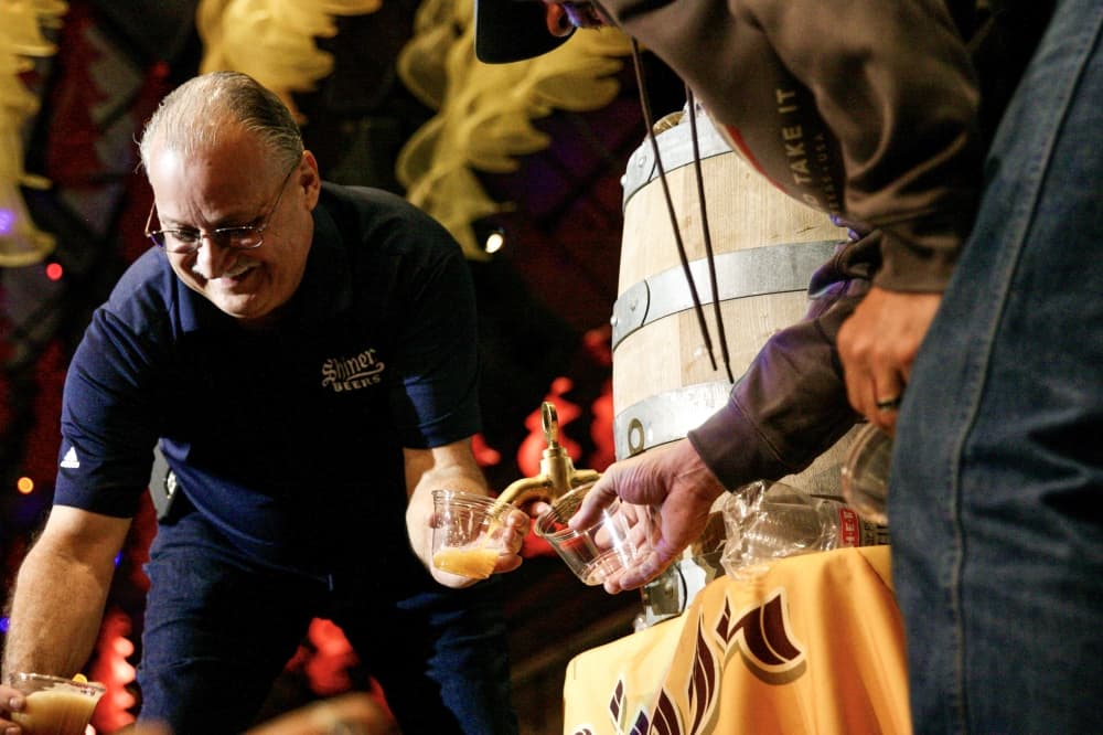 Jimmy Mauric passes out cups of beer to guests. (Lauren Canterberry/Community Impact Newspaper) 