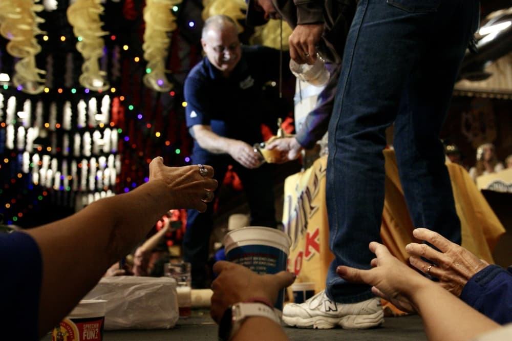 Jimmy Mauric passes out cups of beer to guests. (Lauren Canterberry/Community Impact Newspaper) 