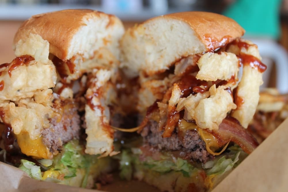 Rodeo Burger ($12.99) is a half-pound burger stacked with cheese, bacon, onion rings and barbecue sauce. (Sierra Rozen/Community Impact Newspaper)