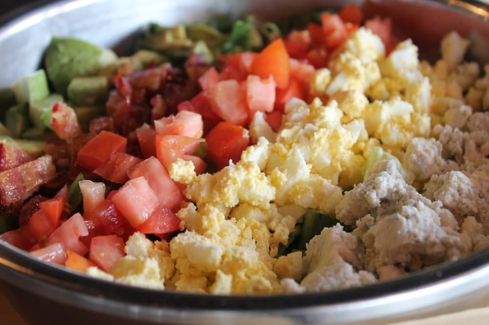 Cobb salad ($9.99) is romaine lettuce topped with bacon, blue cheese crumbles, boiled eggs and avocado. (Sierra Rozen/Community Impact Newspaper)