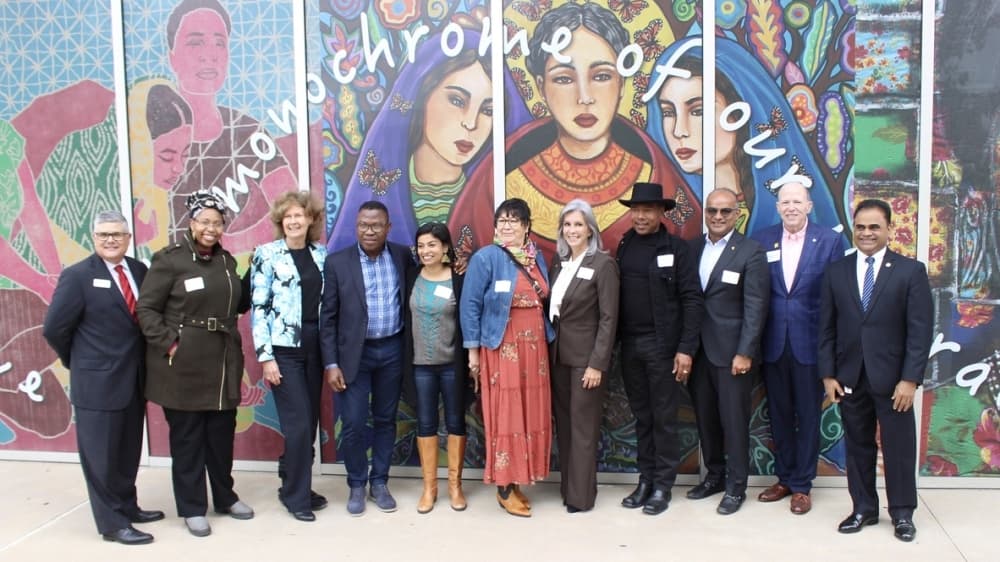 Officials from the University of Houston at Sugar Land, city of Sugar Land, and Fort Bend County as well as artists involved in the project gathered for a ribbon-cutting ceremony for the "Diversity over Division" mural Nov. 4. (Claire Shoop/Community Impact Newspaper)