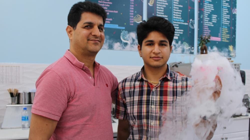 From left, Mehrdad Tabrizi and son Reza use liquid nitrogen to make their gelato. (Olivia Lueckemeyer/Community Impact Newspaper)