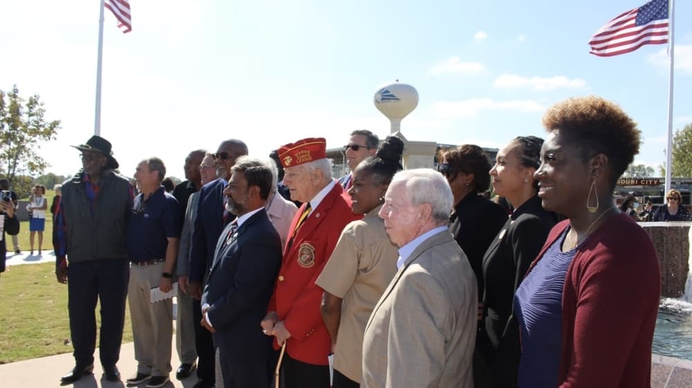 Current and former Missouri City council members gather in front of the memorial. (Claire Shoop/Community Impact Newspaper) 