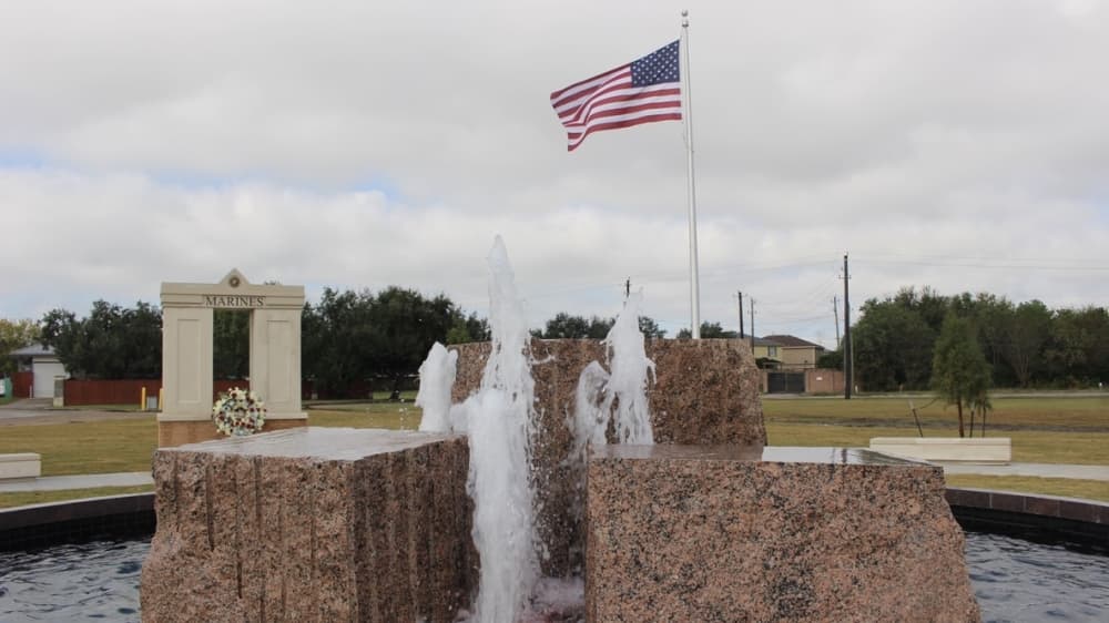The memorial's amber-lit fountain symbolizes an eternal flame, city officials said. (Claire Shoop/Community Impact Newspaper)