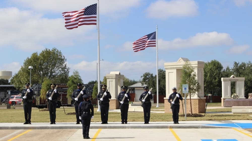 The Missouri City Police Department Rifle Squad participated in a 21-gun salute during the ceremony. (Claire Shoop/Community Impact Newspaper) 