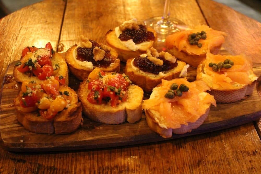The bruschetta trio ($14) includes three each of tomato, basil and garlic, smoked salmon, cream cheese and capers and fig jam, goat cheese and walnuts. (Andrew Christman/Community Impact Newspaper)